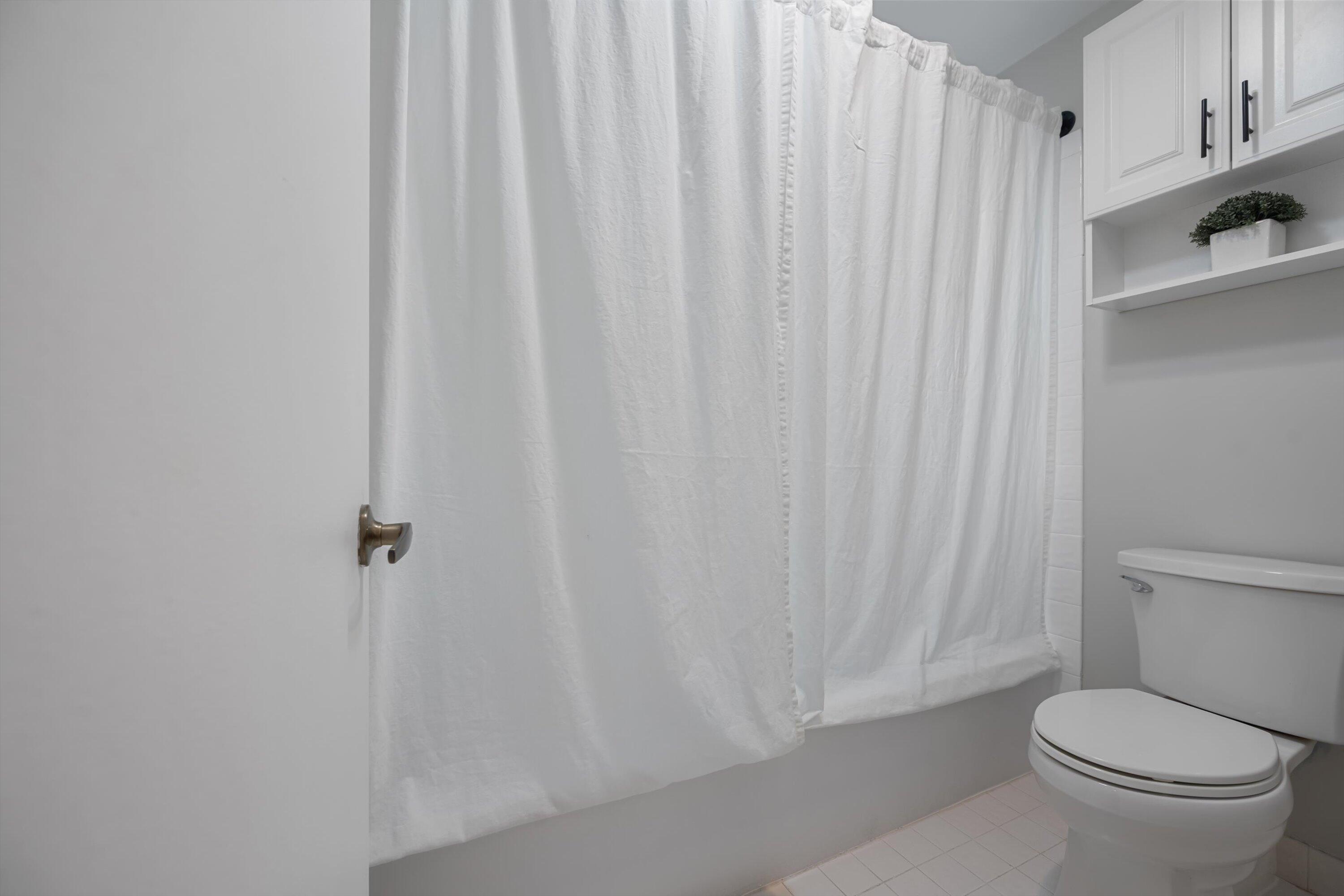 12970 Dartford Trail, Unit 4 Wellington, FL 33414 - Photo 17 of 23 a white toilet sitting next to a shower