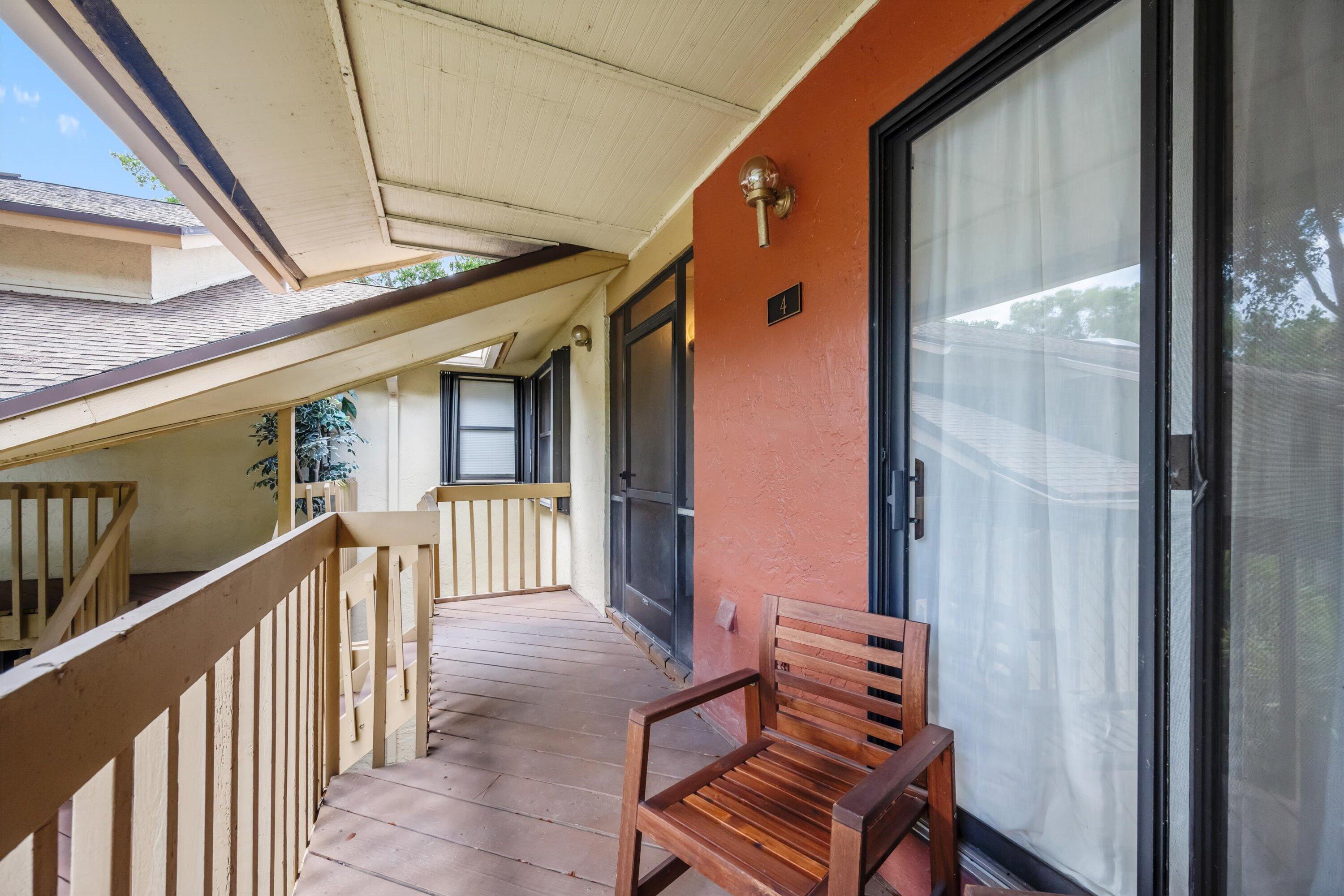 12970 Dartford Trail, Unit 4 Wellington, FL 33414 - Photo 2 of 23 a view of a porch with furniture