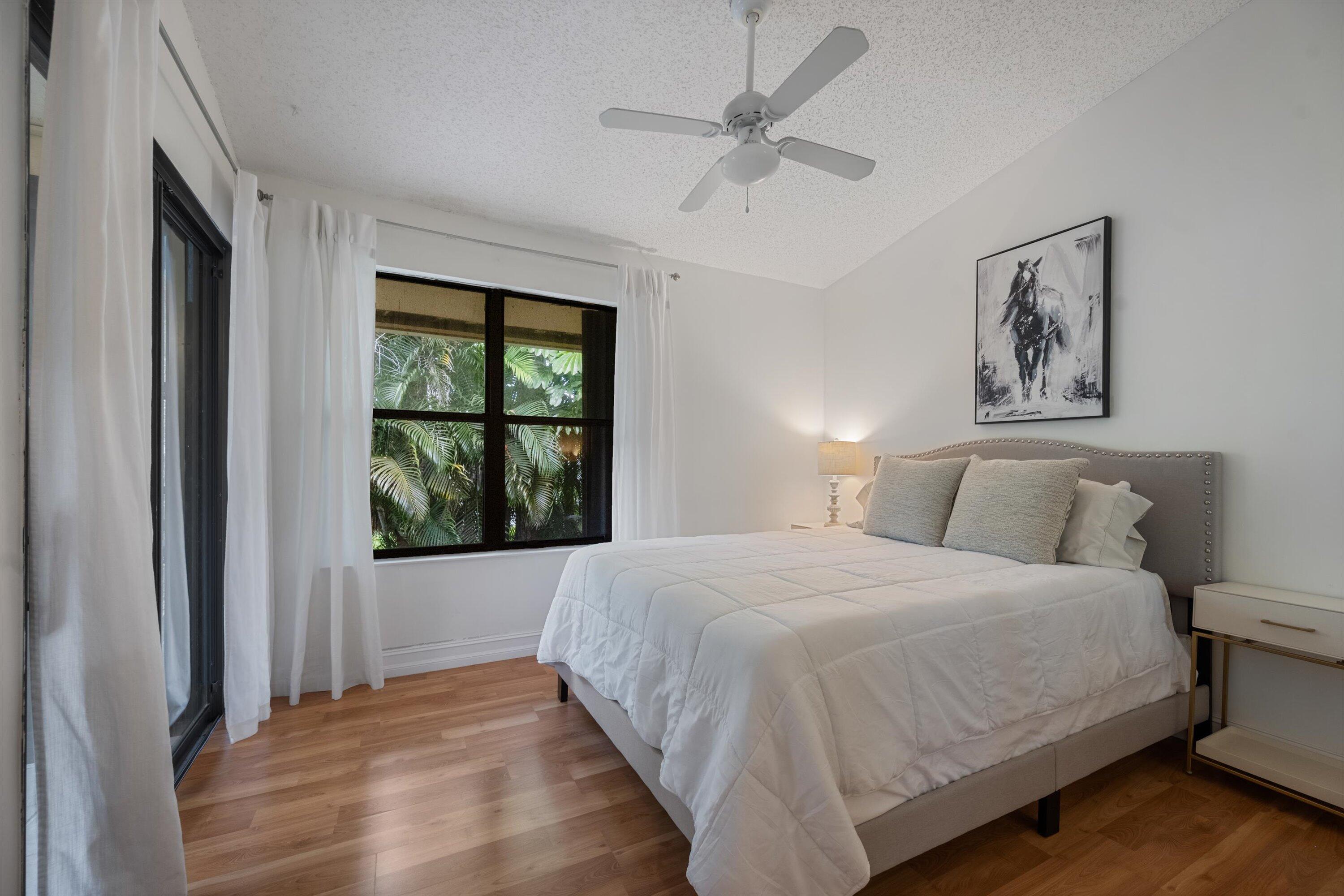 12970 Dartford Trail, Unit 4 Wellington, FL 33414 - Photo 21 of 23 a bedroom with a large bed and a window