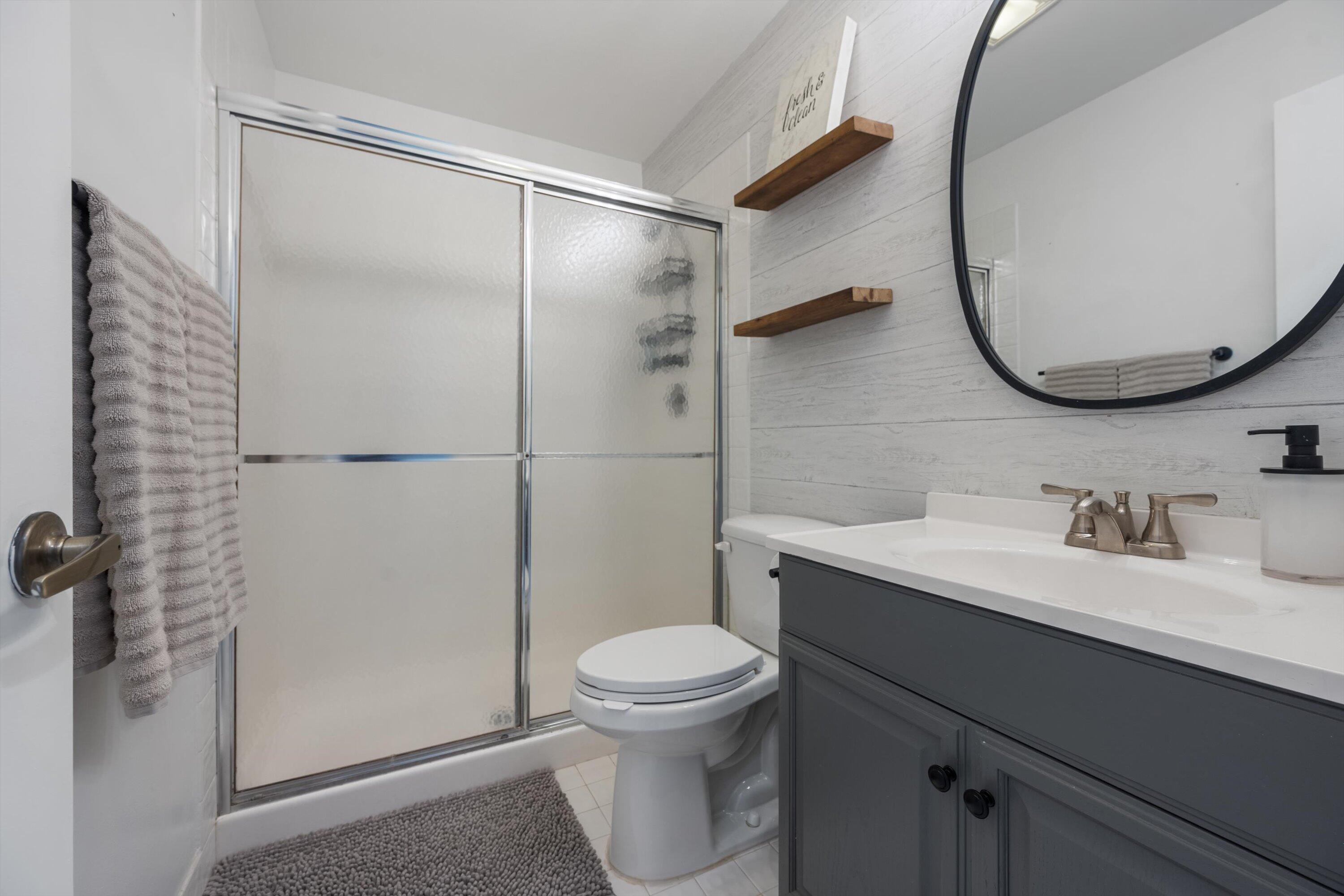 12970 Dartford Trail, Unit 4 Wellington, FL 33414 - Photo 22 of 23 a bathroom with a sink a toilet and a mirror