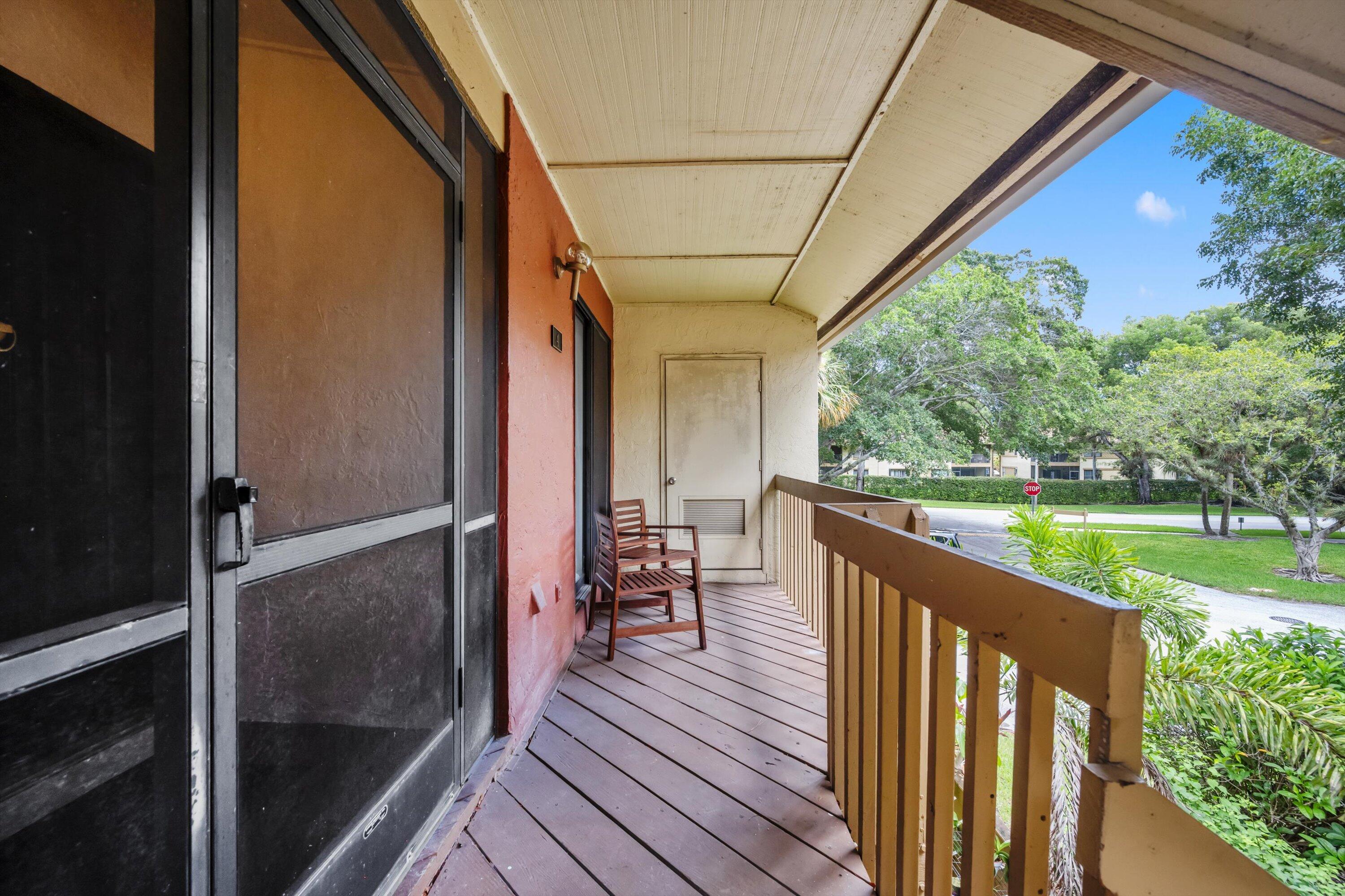 12970 Dartford Trail, Unit 4 Wellington, FL 33414 - Photo 3 of 23 a view of a balcony with chairs