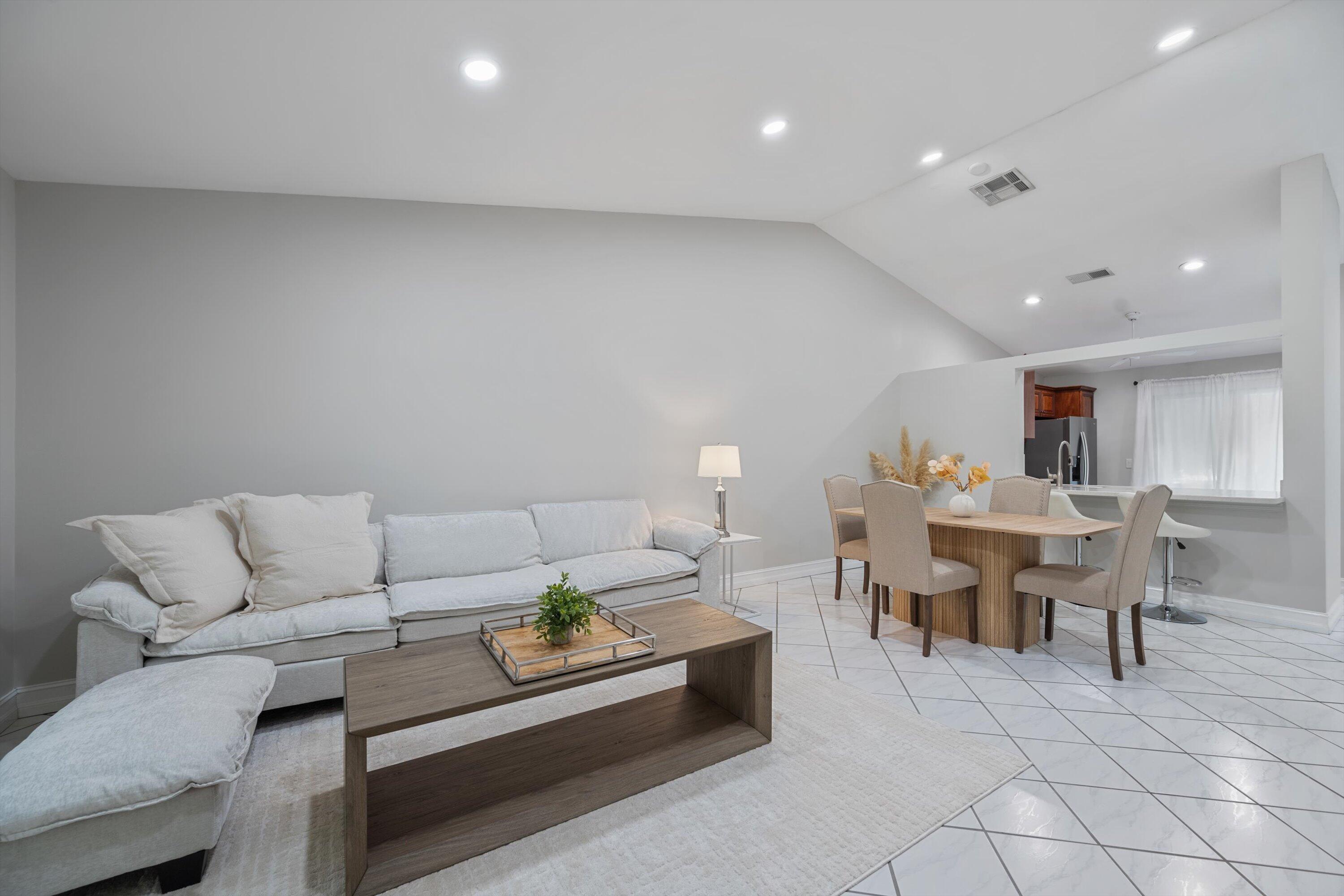 12970 Dartford Trail, Unit 4 Wellington, FL 33414 - Photo 8 of 23 a living room with furniture a dining table and a piano