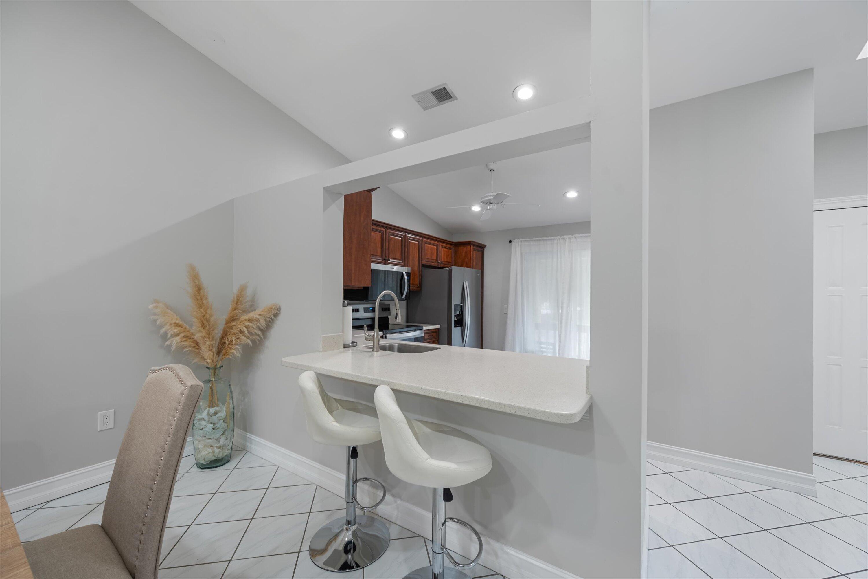 12970 Dartford Trail, Unit 4 Wellington, FL 33414 - Photo 10 of 23 a view of kitchen with furniture and wooden floor