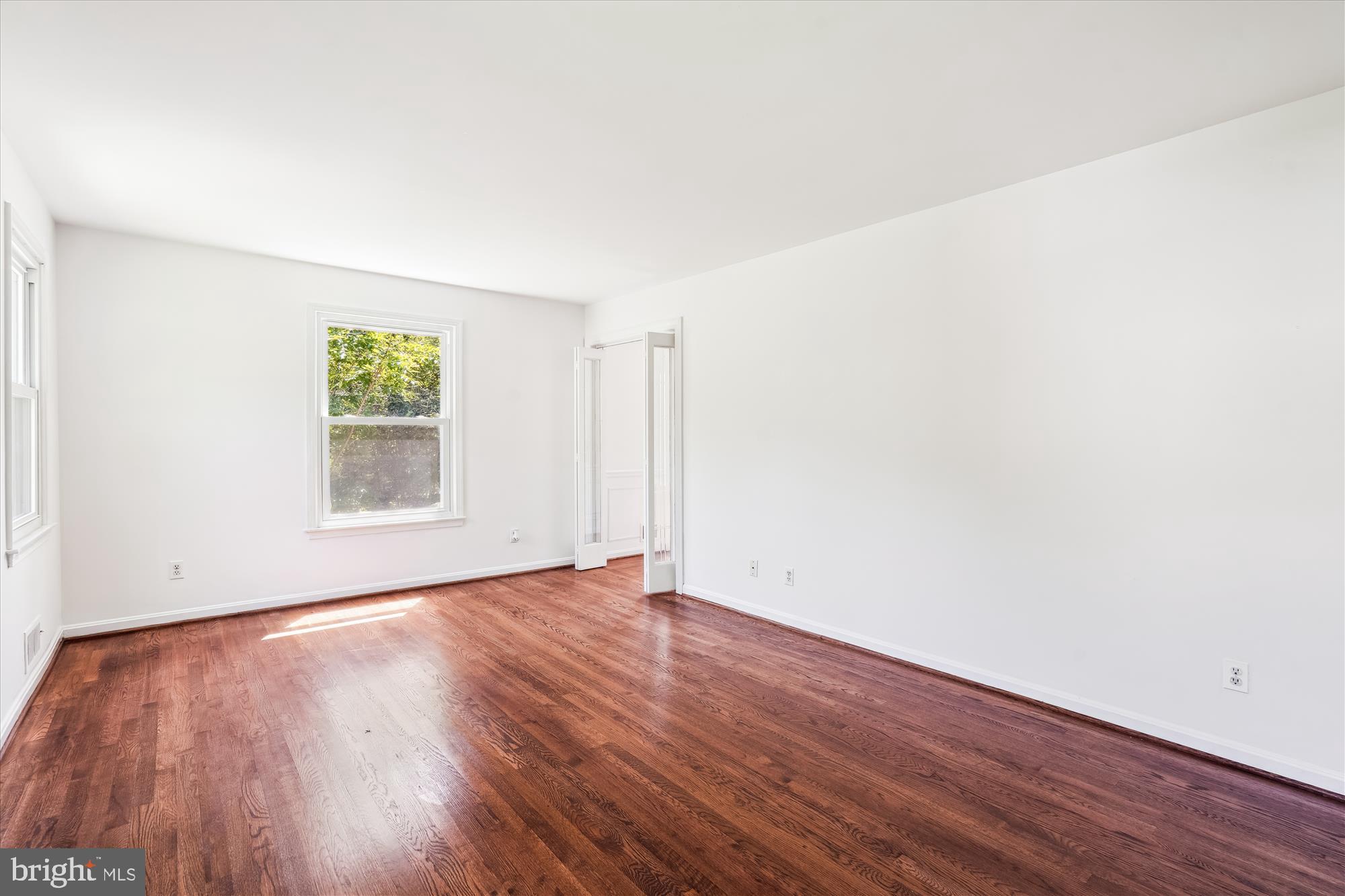 2445 Parallel Lane Silver Spring, MD 20904 - Photo 14 of 82 an empty room with wooden floor and windows