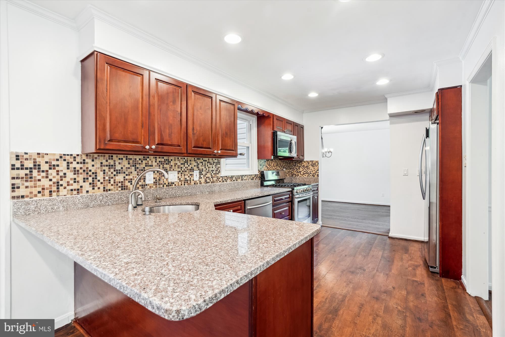 2445 Parallel Lane Silver Spring, MD 20904 - Photo 20 of 82 a kitchen with stainless steel appliances granite countertop a sink dishwasher and a refrigerator with wooden floor