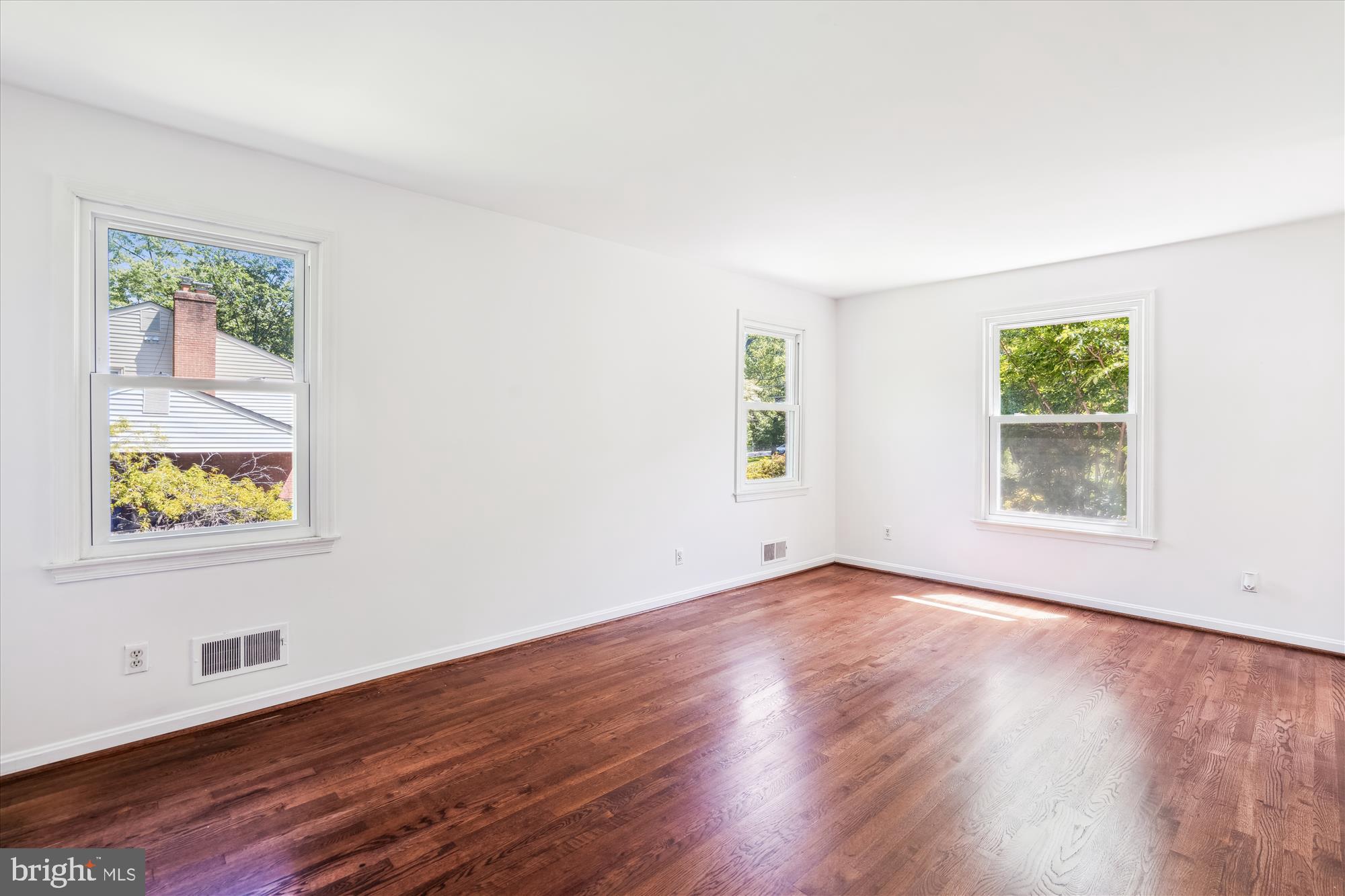 2445 Parallel Lane Silver Spring, MD 20904 - Photo 2 of 82 a view of an empty room with wooden floor and a window