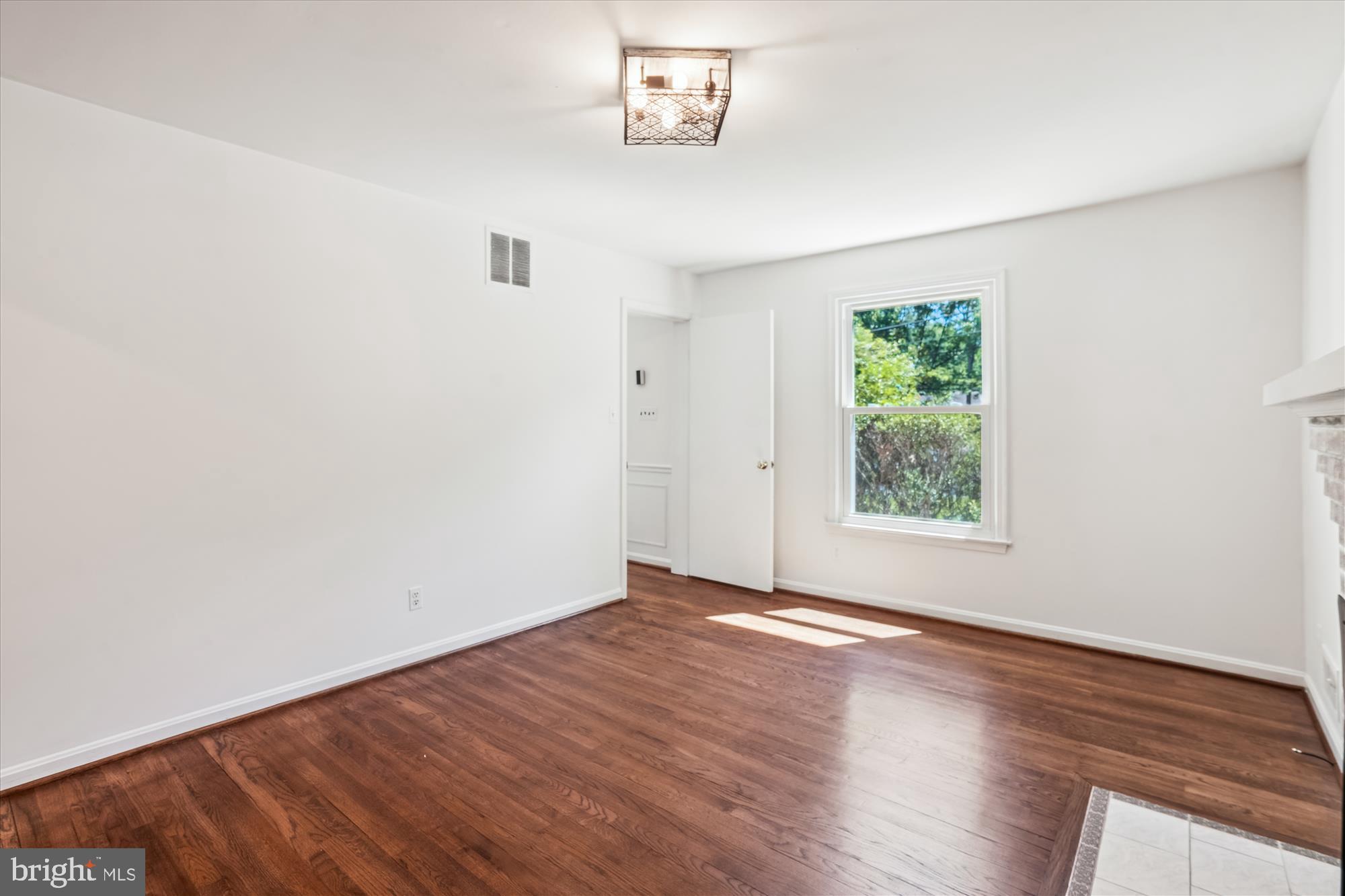 2445 Parallel Lane Silver Spring, MD 20904 - Photo 23 of 82 an empty room with wooden floor and windows