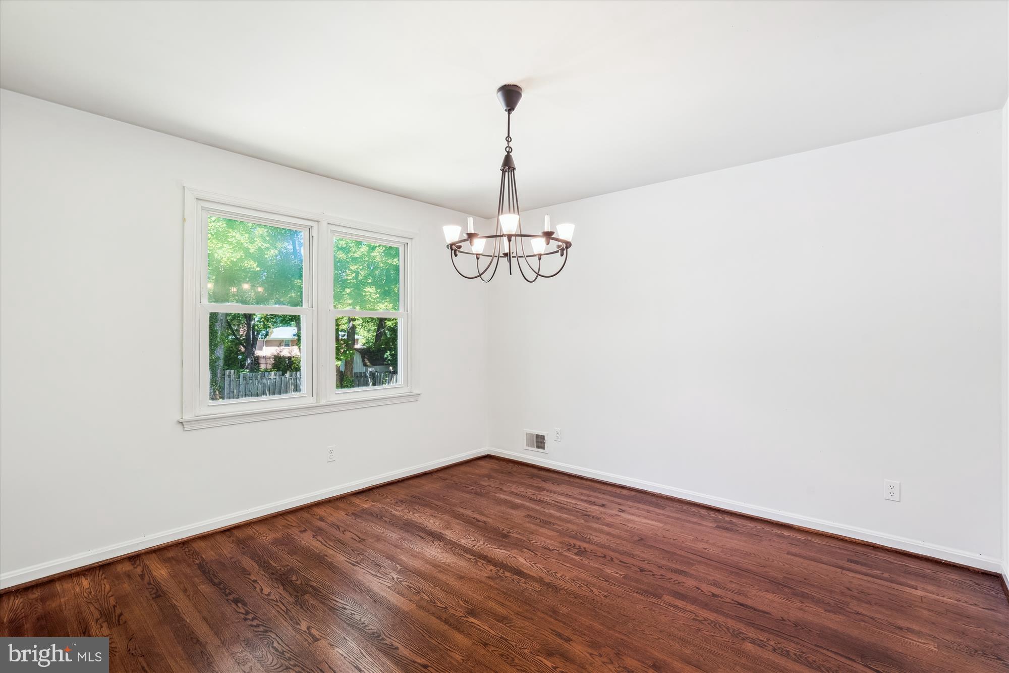 2445 Parallel Lane Silver Spring, MD 20904 - Photo 3 of 82 an empty room with wooden floor chandelier and windows