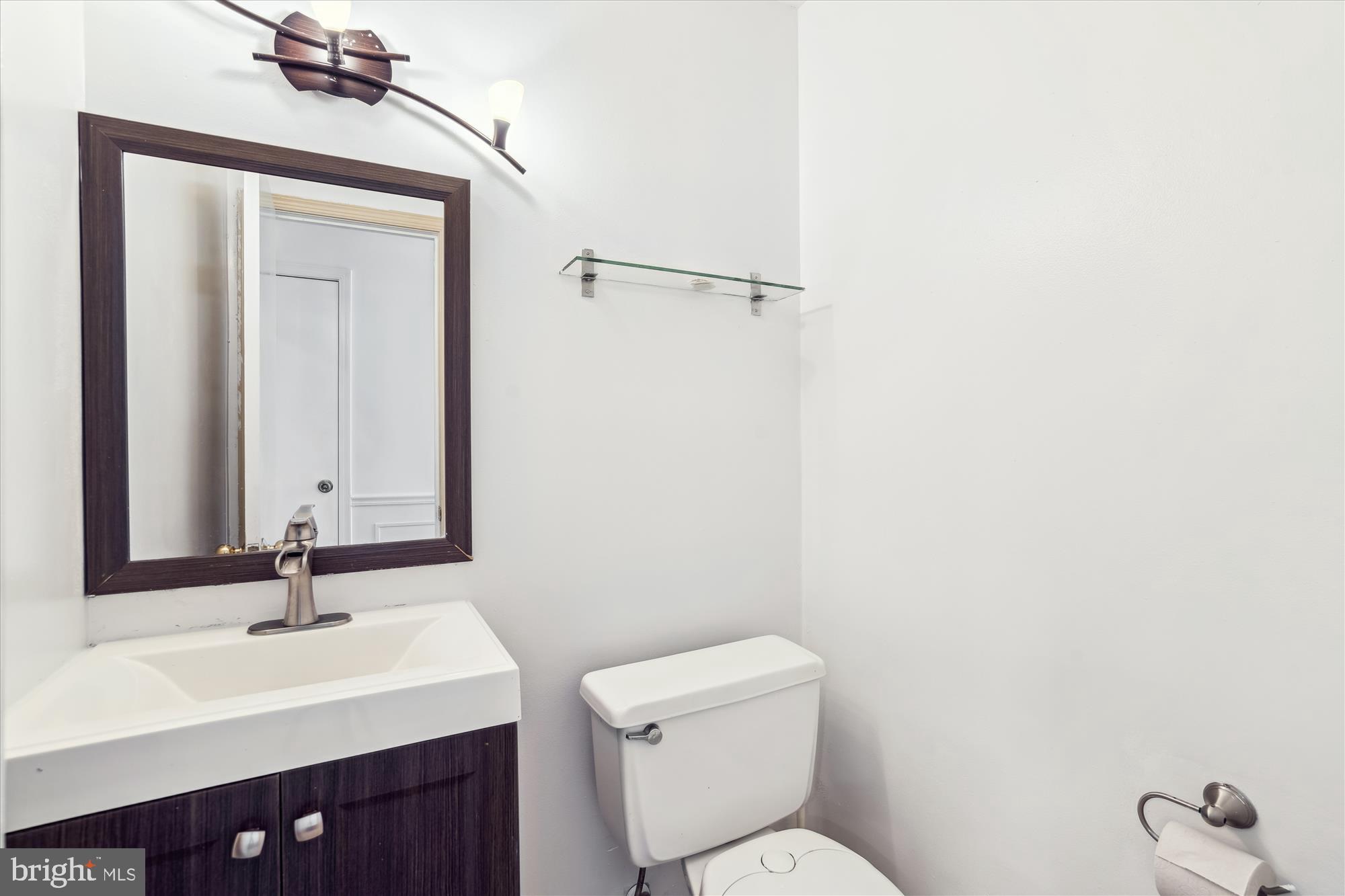 2445 Parallel Lane Silver Spring, MD 20904 - Photo 34 of 82 a bathroom with a toilet a sink a mirror and vanity