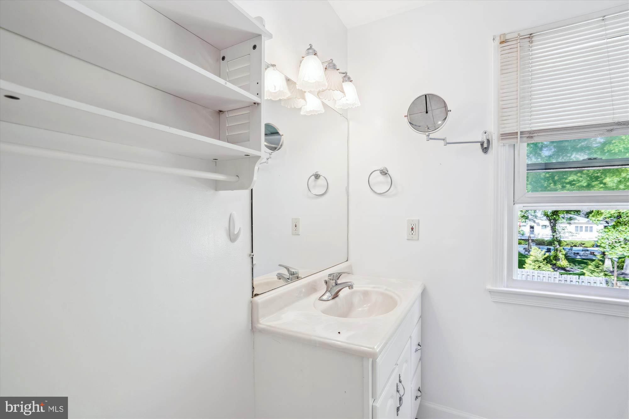 2445 Parallel Lane Silver Spring, MD 20904 - Photo 40 of 82 a bathroom with a sink a mirror and window