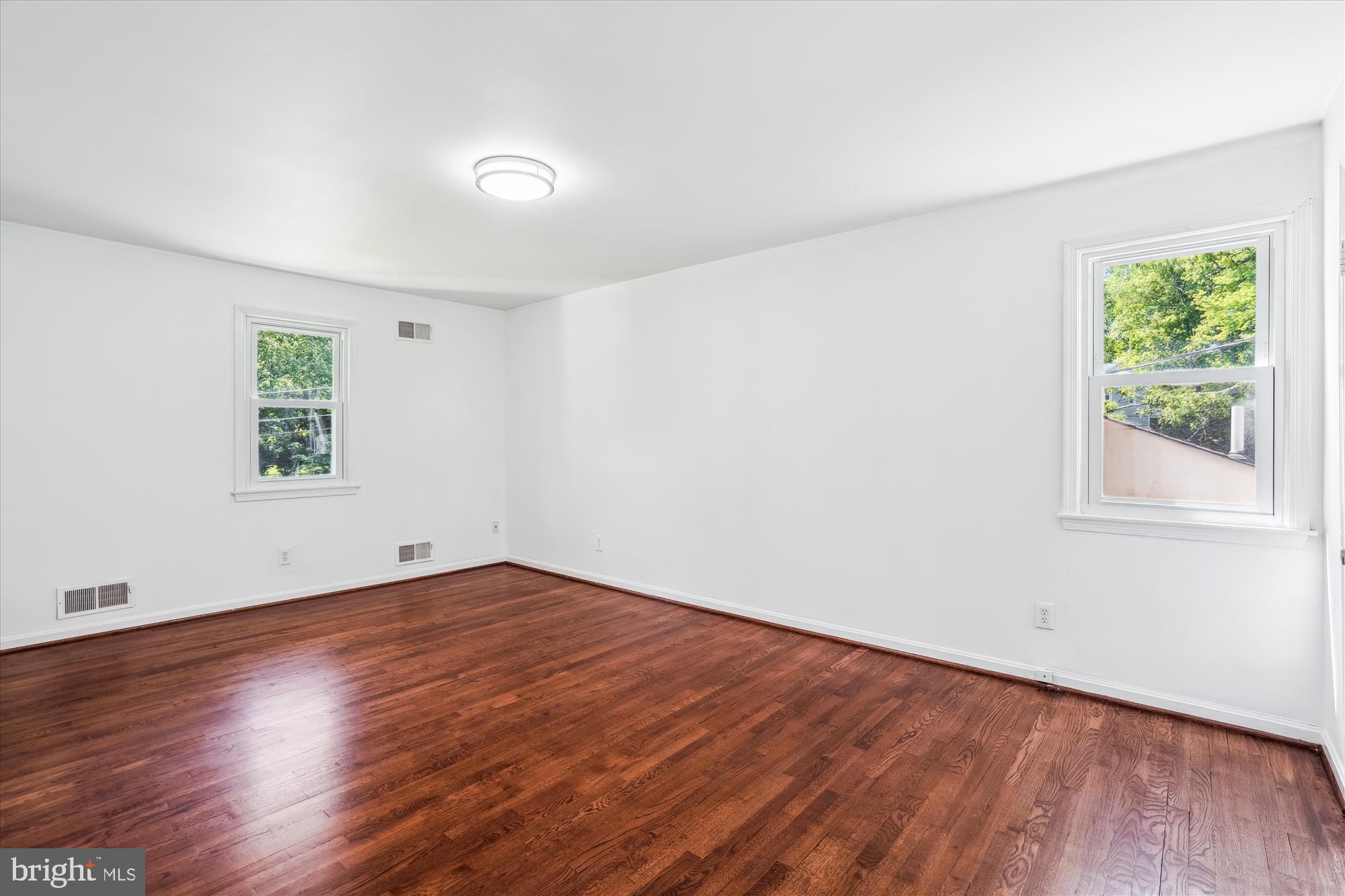 2445 Parallel Lane Silver Spring, MD 20904 - Photo 43 of 82 an empty room with wooden floor and windows