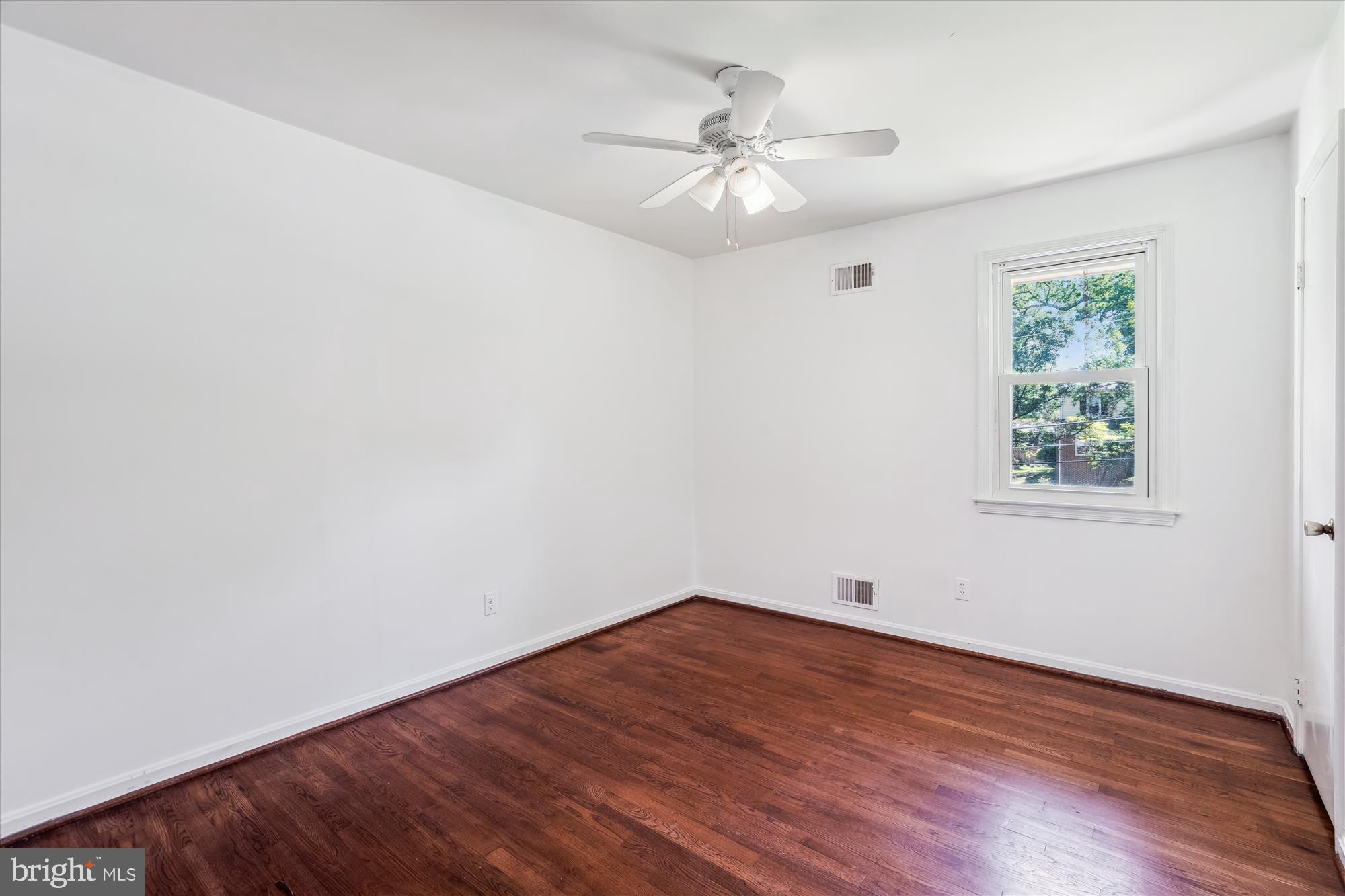 2445 Parallel Lane Silver Spring, MD 20904 - Photo 45 of 82 a view of an empty room with wooden floor and a window