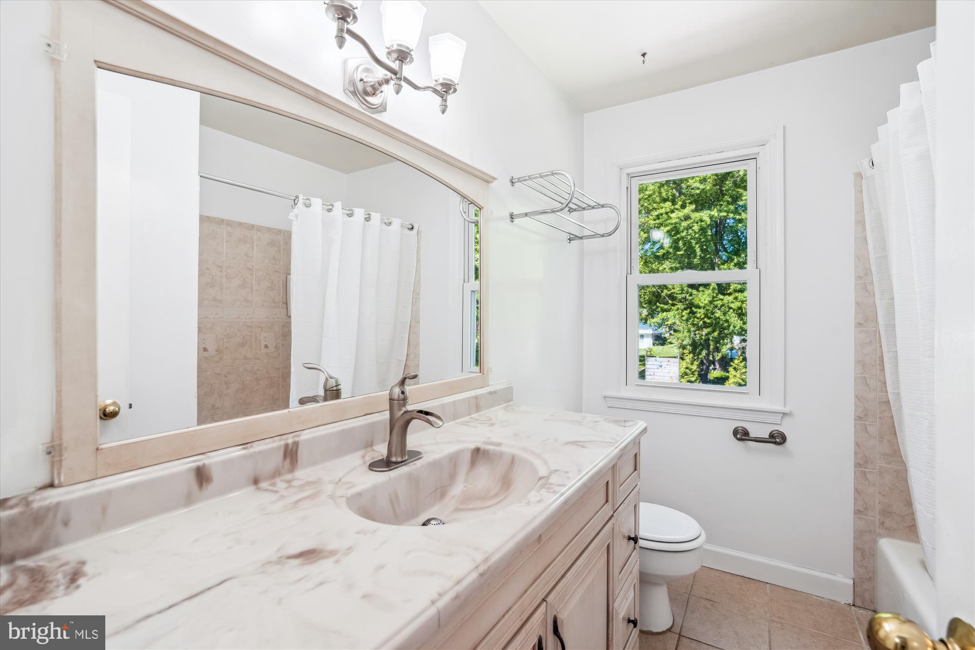2445 Parallel Lane Silver Spring, MD 20904 - Photo 47 of 82 a bathroom with a granite countertop sink toilet and shower