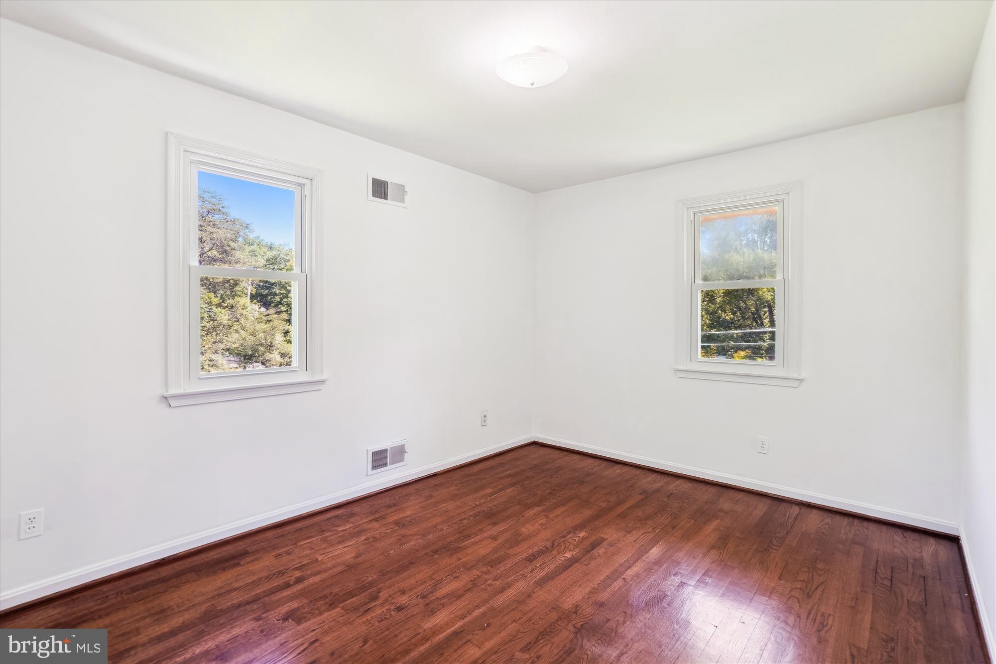 2445 Parallel Lane Silver Spring, MD 20904 - Photo 49 of 82 a view of an empty room with wooden floor and a window