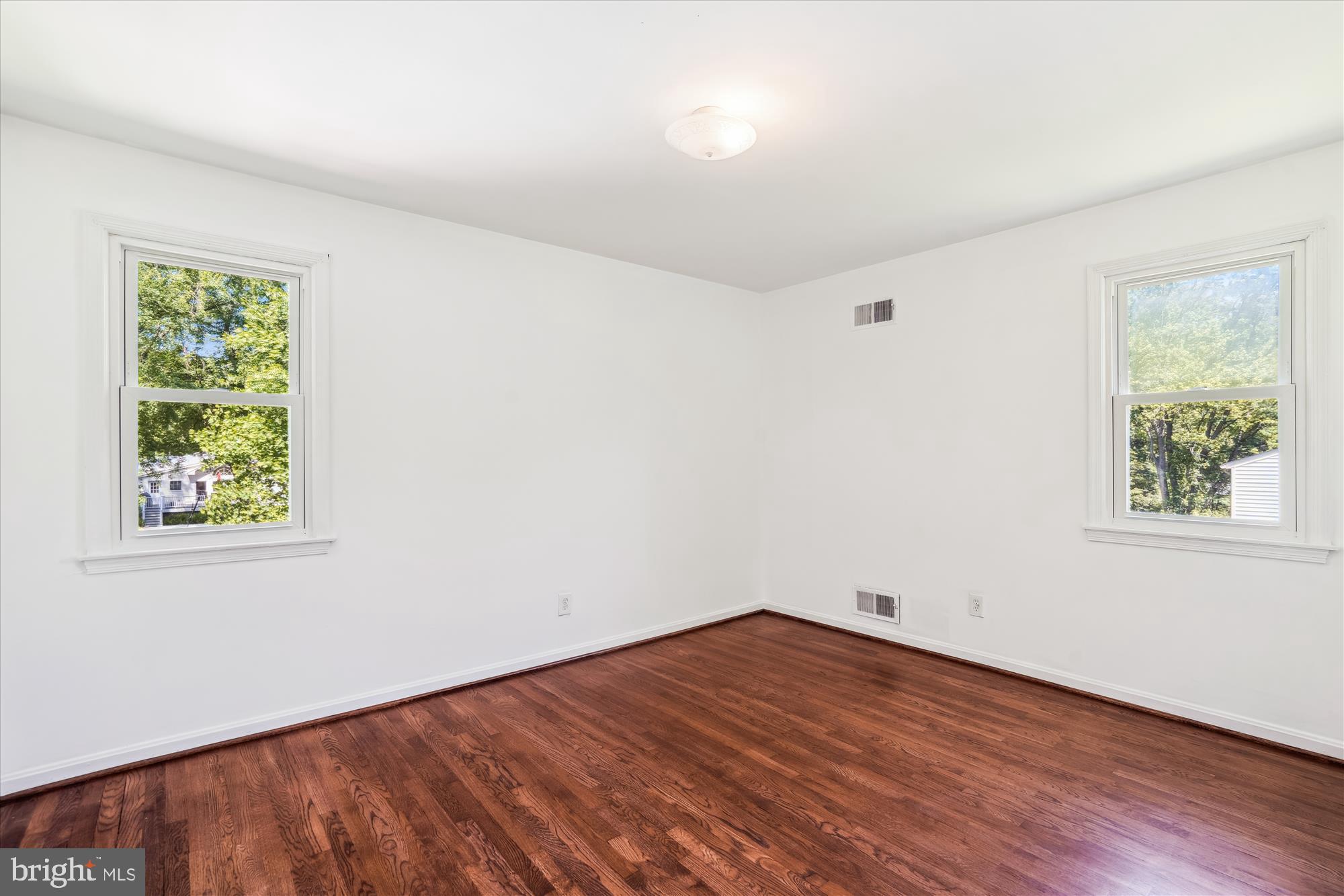 2445 Parallel Lane Silver Spring, MD 20904 - Photo 51 of 82 an empty room with wooden floor and windows