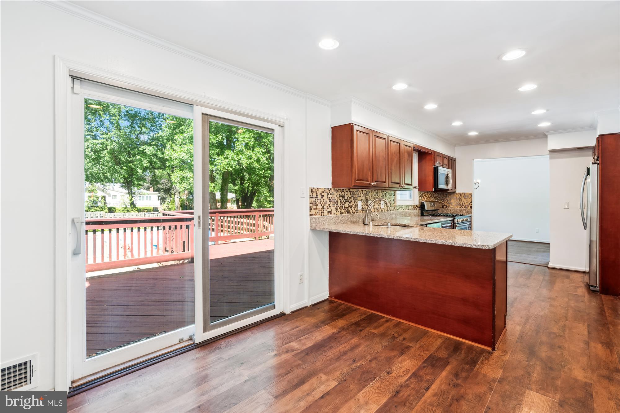 2445 Parallel Lane Silver Spring, MD 20904 - Photo 6 of 82 a kitchen with stainless steel appliances granite countertop a refrigerator stove and oven with wooden floor