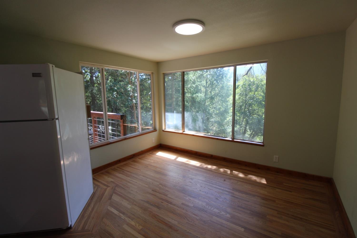 8775 North Applegate Road Grants Pass, OR 97527 - Photo 13 of 31 a view of a room with wooden floor and a window