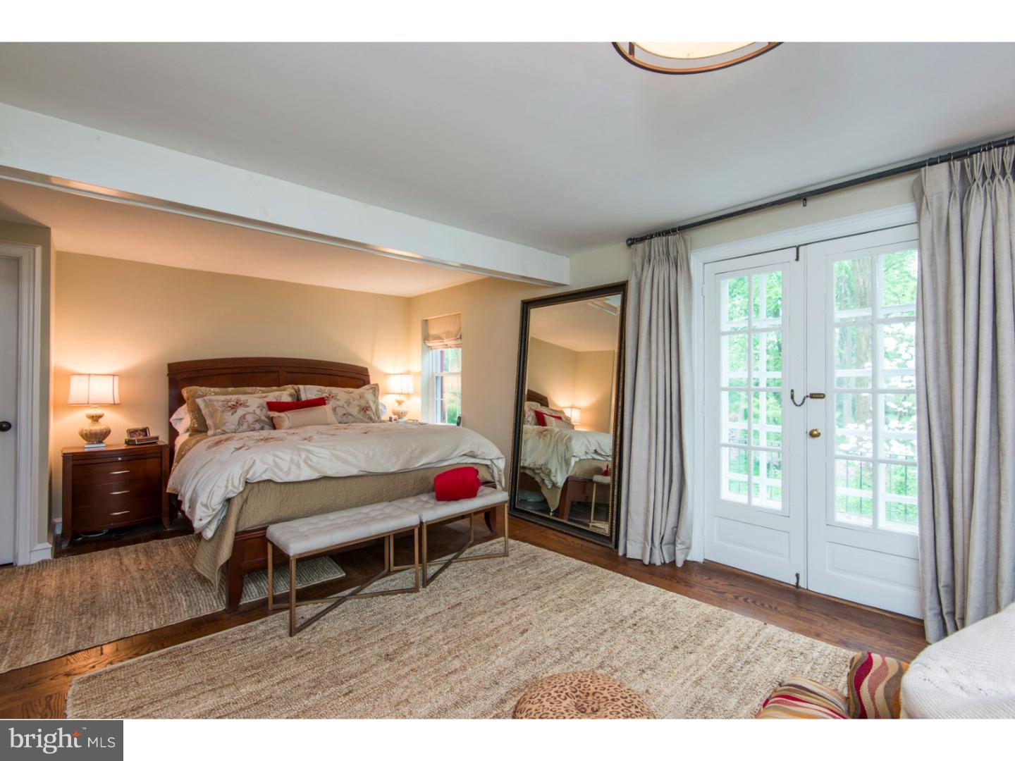 16 Wistar Road Villanova, PA 19085 - Photo 13 of 25 a bedroom with a bed a mirror and a window