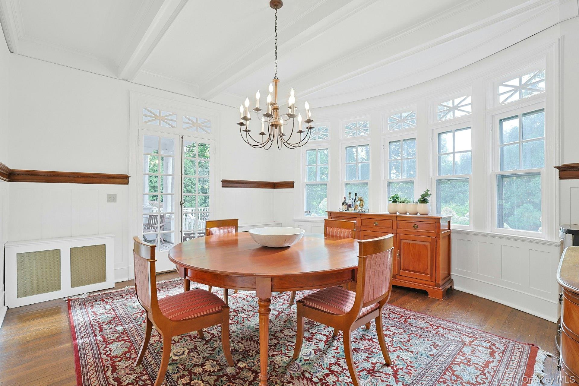 49 Overlook Circle New Rochelle, NY 10804 - Photo 13 of 47 a dining room with furniture a chandelier and wooden floor