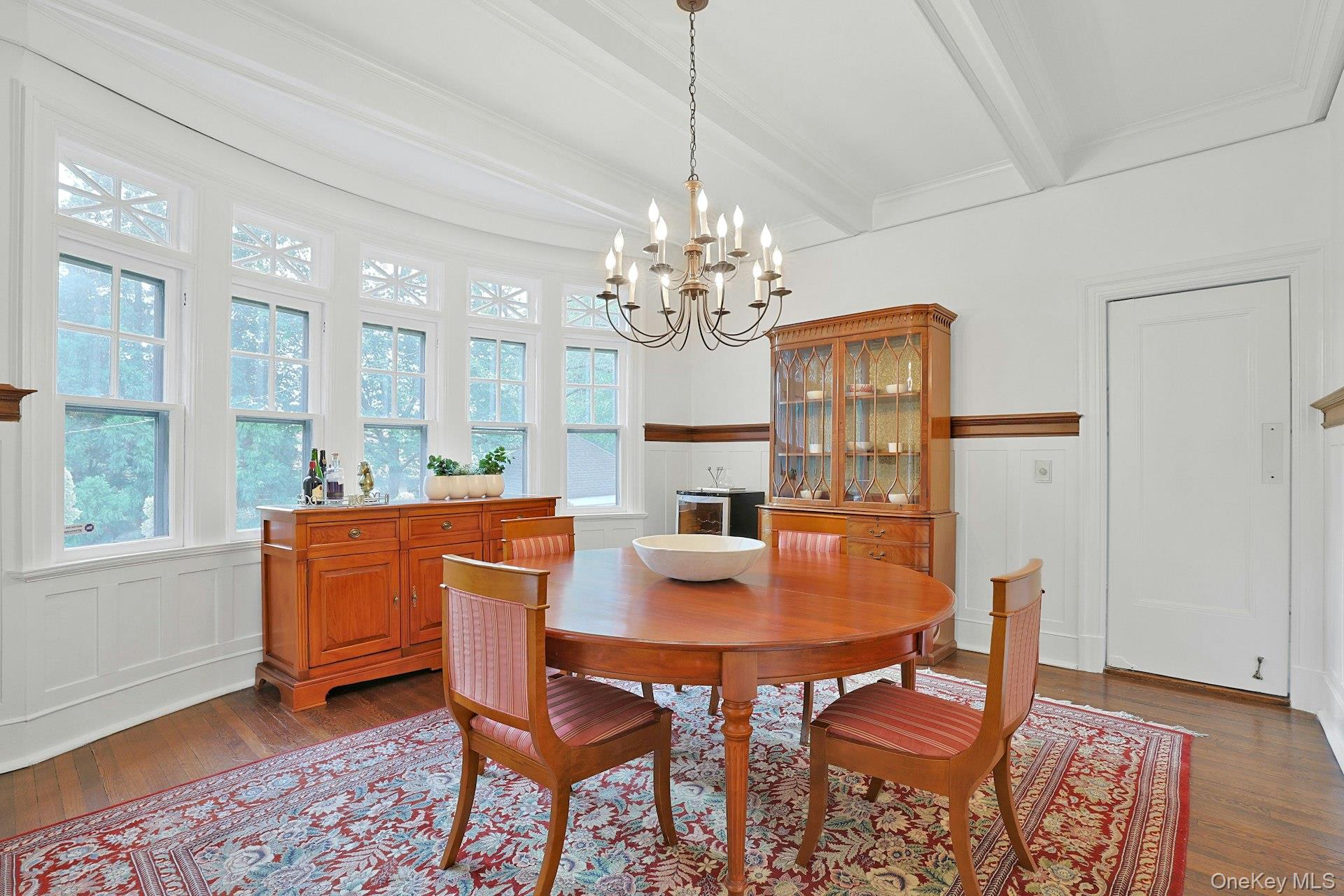 49 Overlook Circle New Rochelle, NY 10804 - Photo 14 of 47 a dining room with furniture a chandelier and wooden floor