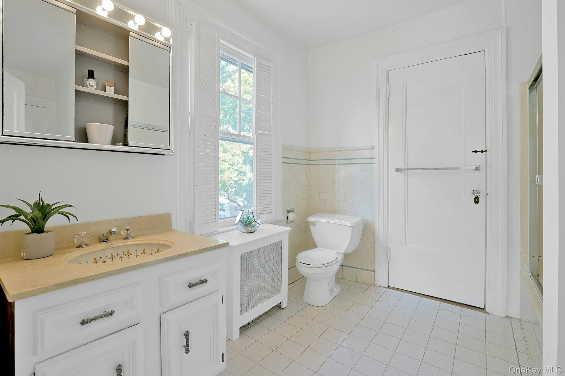 49 Overlook Circle New Rochelle, NY 10804 - Photo 34 of 47 a bathroom with a granite countertop sink mirror vanity and toilet