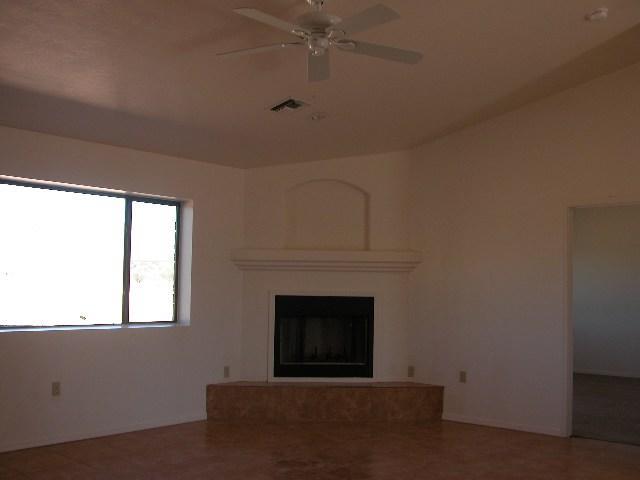 1793 Fritz Court Rio Rico, AZ 85648 - Photo 2 of 8 a living room with a fireplace and a window