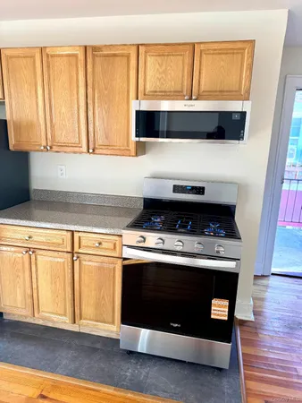 a kitchen with stainless steel appliances granite countertop a stove and a microwave oven