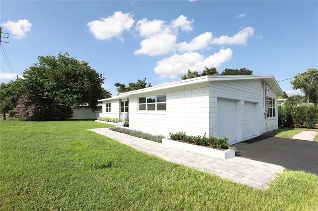 a view of a house with a yard and garage