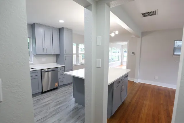 a view of empty room with wooden floor and window