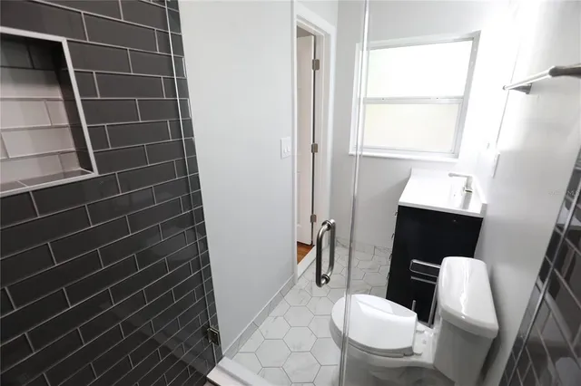 a bathroom with a toilet sink and window