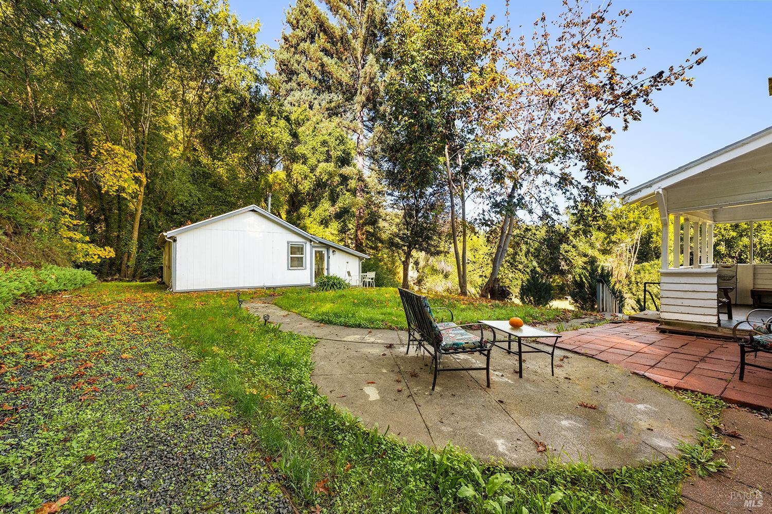 1194 Felta Road Healdsburg, CA 95448 - Photo 27 of 52 a view of a backyard with table and chairs and a tree