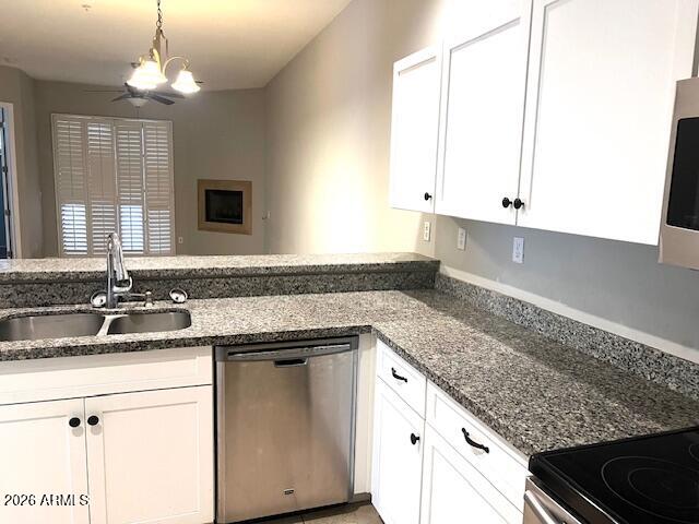 8270 North Hayden Road, Unit 1042 Scottsdale, AZ 85258 - Photo 22 of 30 a kitchen with granite countertop a sink and white cabinets