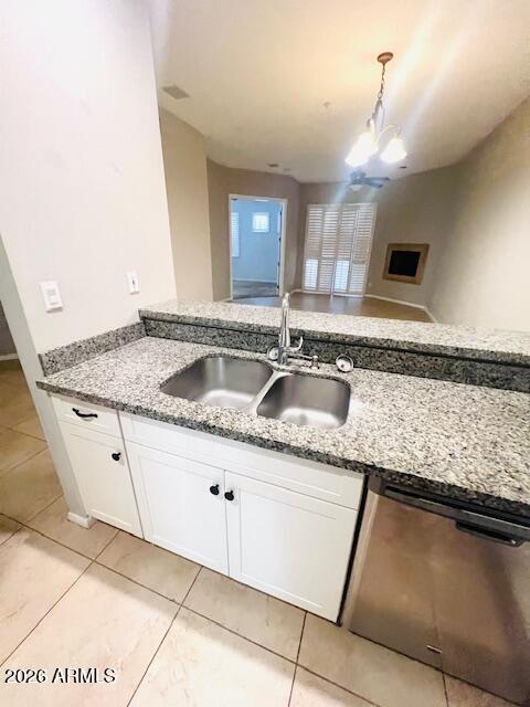 8270 North Hayden Road, Unit 1042 Scottsdale, AZ 85258 - Photo 29 of 30 a kitchen with granite countertop a sink a stove and cabinets