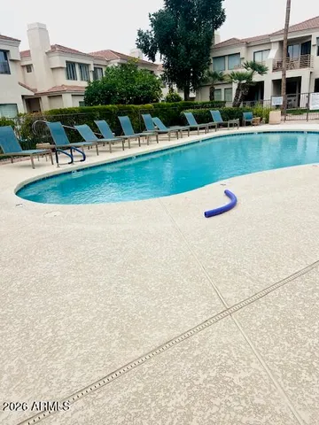 swimming pool view with tall buildings in the background