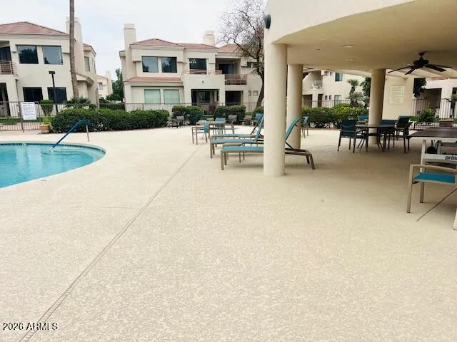 a view of a patio with dining table and chairs