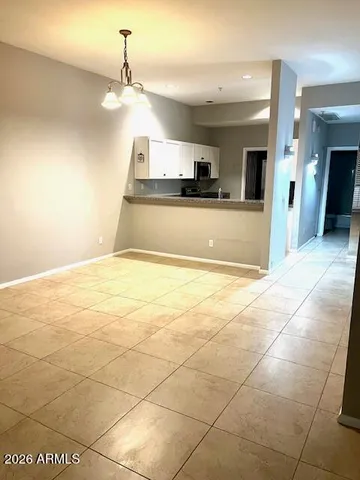 a view of a kitchen with a sink and a stove top open