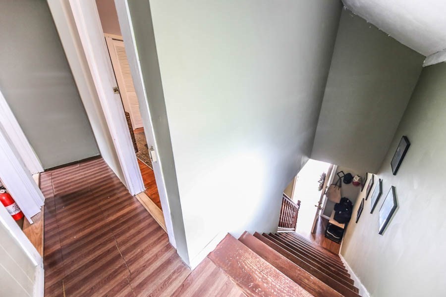 4 Riverview Place Lawrence, MA 01841 - Photo 13 of 21 a view of a bedroom with wooden floor and stairs