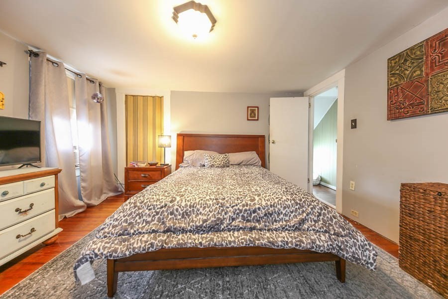 4 Riverview Place Lawrence, MA 01841 - Photo 14 of 21 a bedroom with a bed and wooden floor