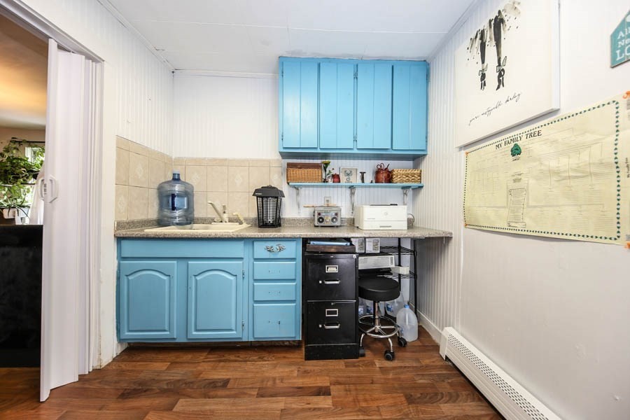 4 Riverview Place Lawrence, MA 01841 - Photo 18 of 21 a kitchen with granite countertop wooden cabinets and white appliances