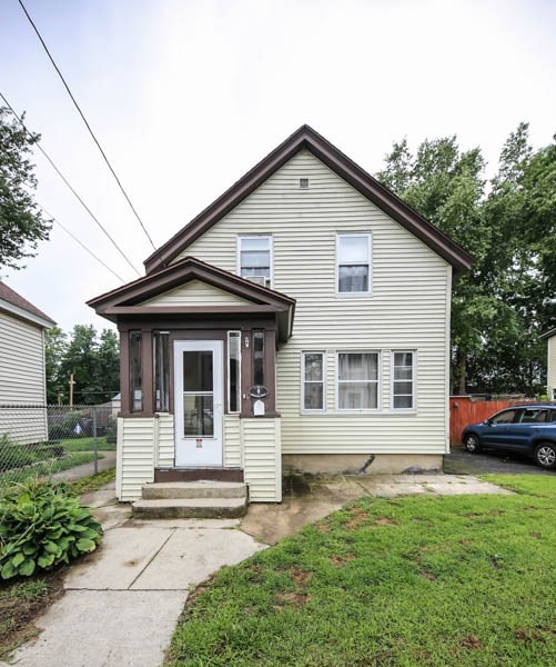4 Riverview Place Lawrence, MA 01841 - Photo 3 of 21 a front view of a house with a yard