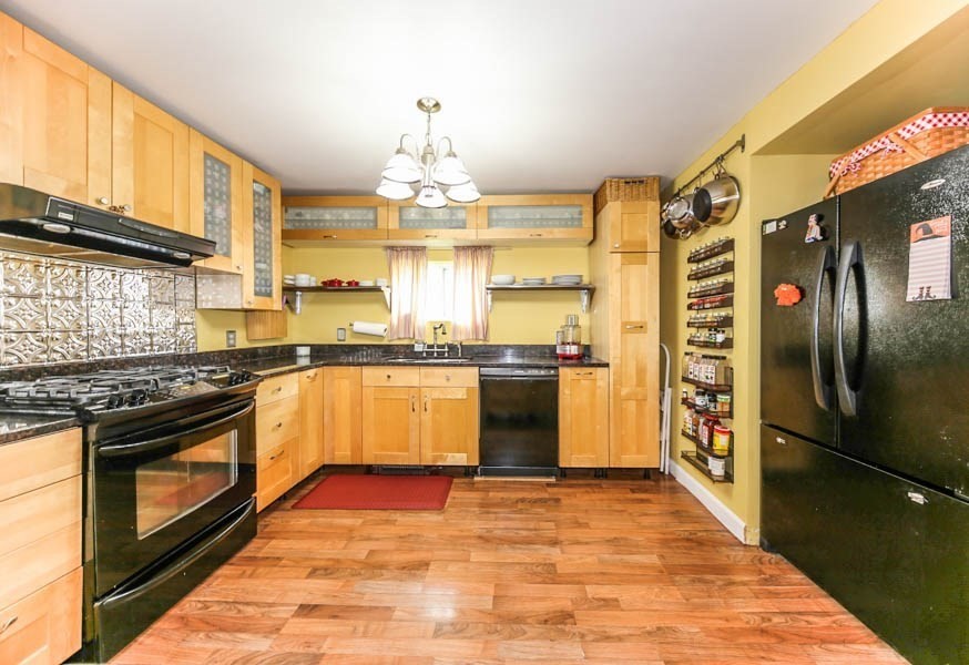 4 Riverview Place Lawrence, MA 01841 - Photo 10 of 21 a large kitchen with stainless steel appliances granite countertop a stove and a refrigerator
