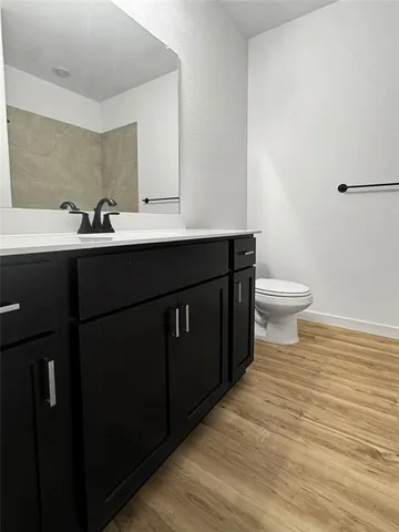 a bathroom with a glass door shower a sink and a mirror