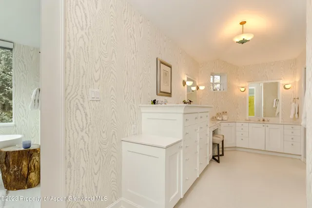 a bathroom with a sink a vanity and a mirror