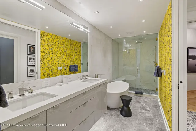 a bathroom with a double vanity sink toilet mirror and shower