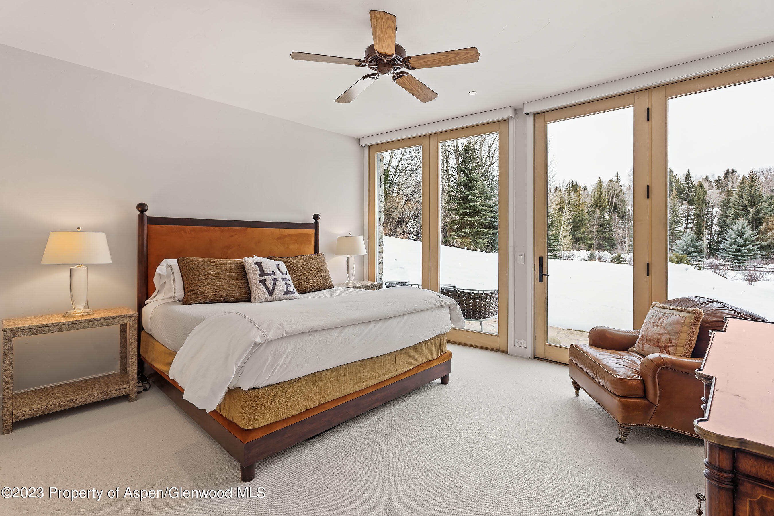 58 Pitkin Way Aspen, CO 81611 - Photo 19 of 33 a bedroom with a bed couch and a large window