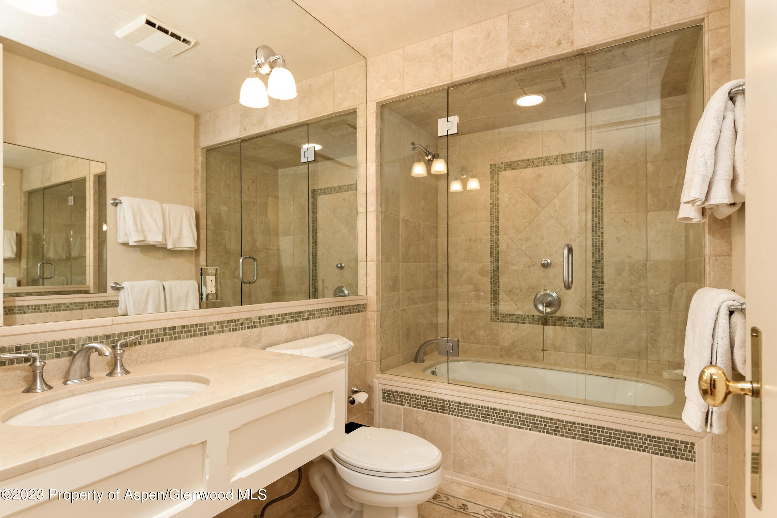 58 Pitkin Way Aspen, CO 81611 - Photo 20 of 33 a bathroom with a granite countertop tub toilet sink and mirror