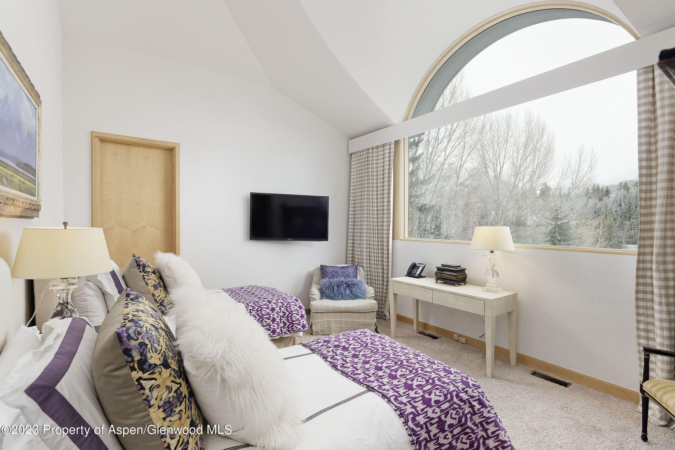 58 Pitkin Way Aspen, CO 81611 - Photo 21 of 33 a bedroom with a bed and large windows