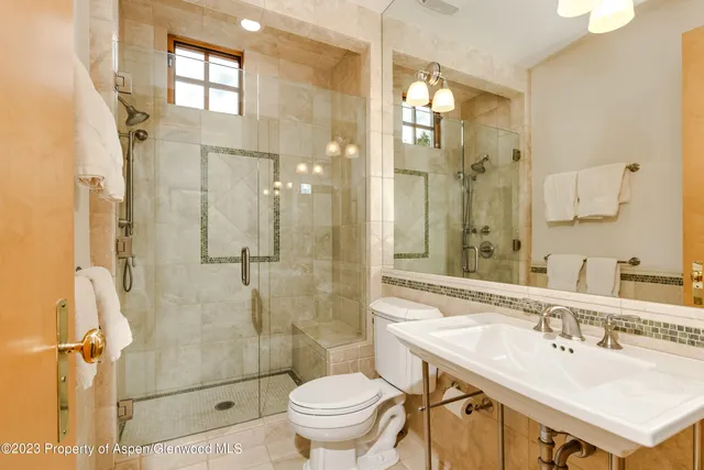 a bathroom with a sink toilet and shower