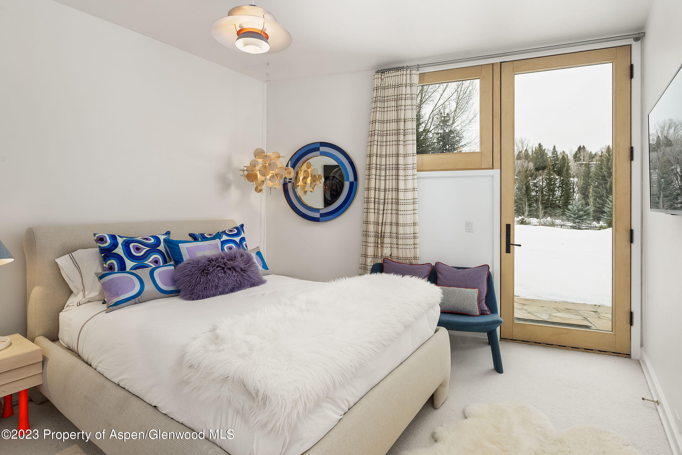 58 Pitkin Way Aspen, CO 81611 - Photo 23 of 33 a bedroom with a bed and a window