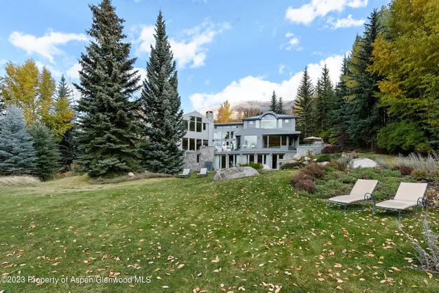 a view of a house with a backyard porch and sitting area